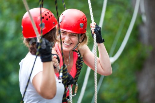 Two girls laughing on a high ropes course in Costa Rica